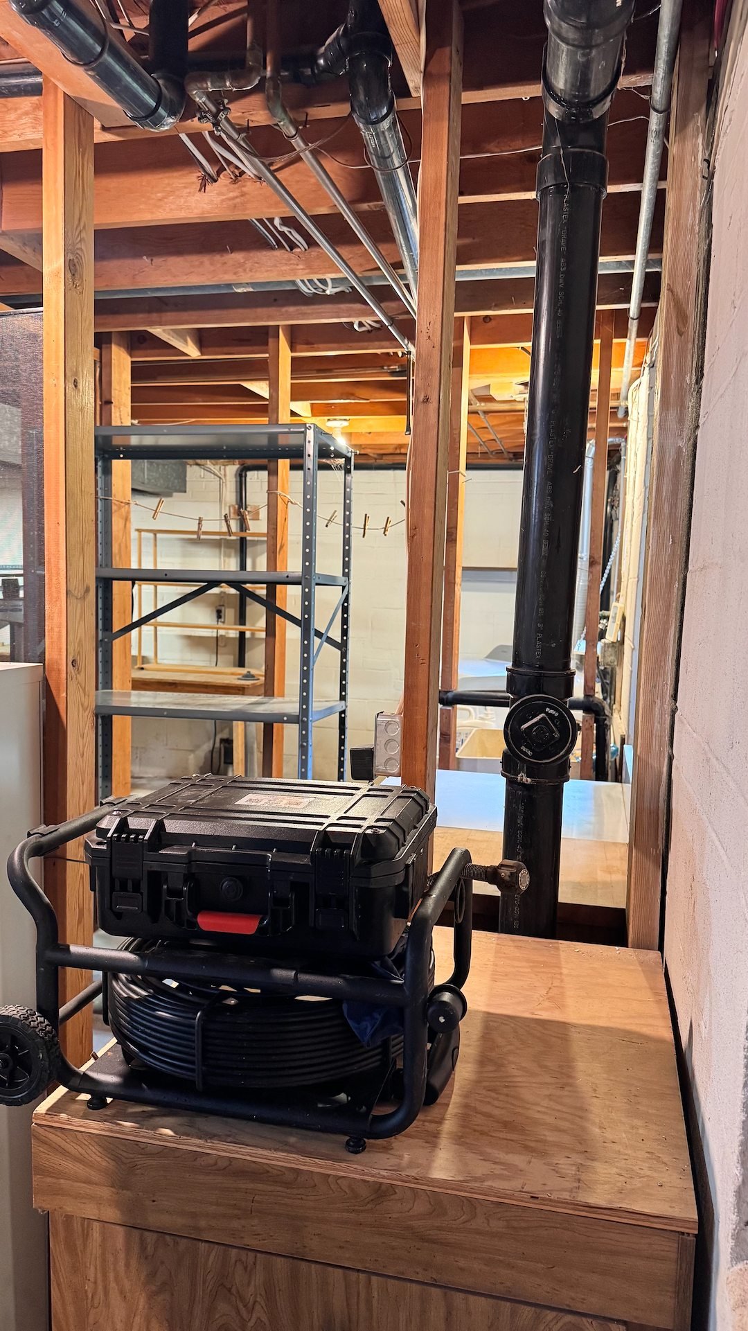 Drain inspection camera set up at a basement cleanout before drain cleaning in Alexandria, VA
