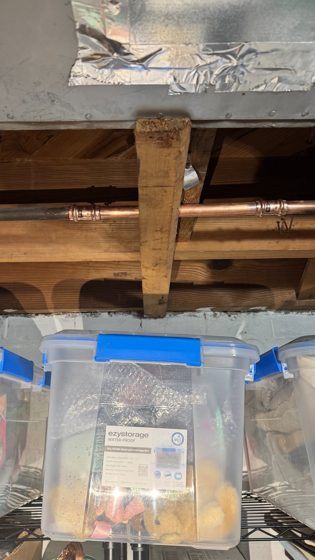 Opened ceiling exposing copper pipes during a pinhole leak repair in Alexandria, VA